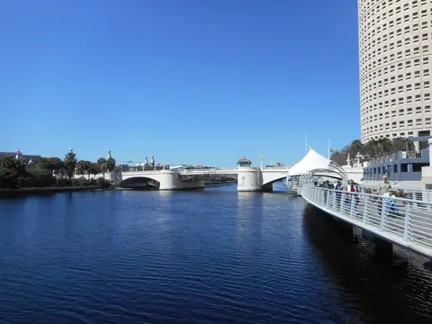 The Tampa Riverwalk along the Hillsborough River downtown, with the Kennedy Boulevard bridge