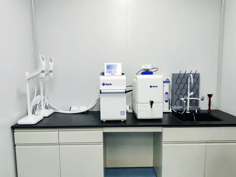 Two water purification units on a counter beside a small sink